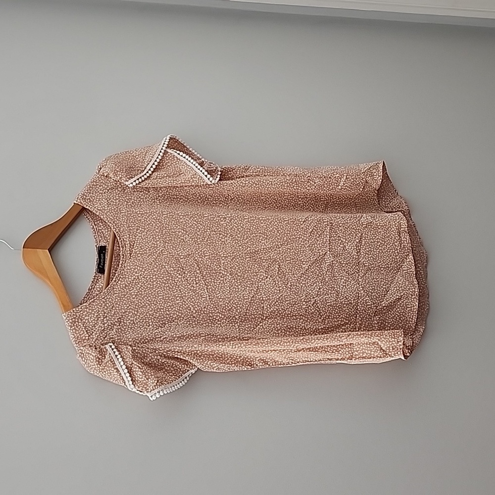 Short sleeve casual fit dusty rose colored blouse.